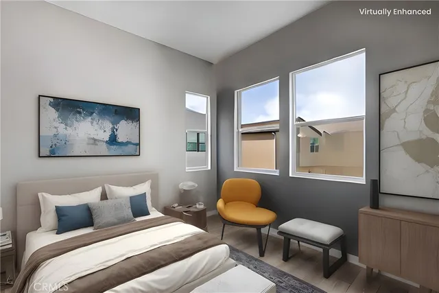 a bedroom with a bed and a window with chair