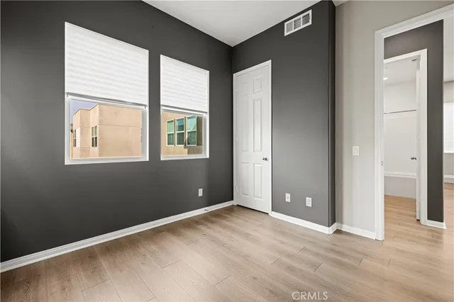 an empty room with windows and closet