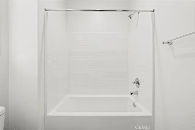 a bathroom with a shower and a bath tub