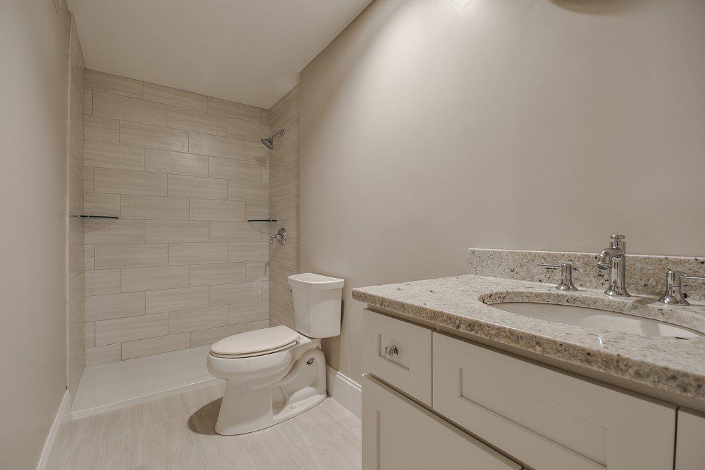 7 Bryn Mawr Road Wellesley, MA 02482 - Photo 28 of 30 a bathroom with a granite countertop sink a toilet and a mirror