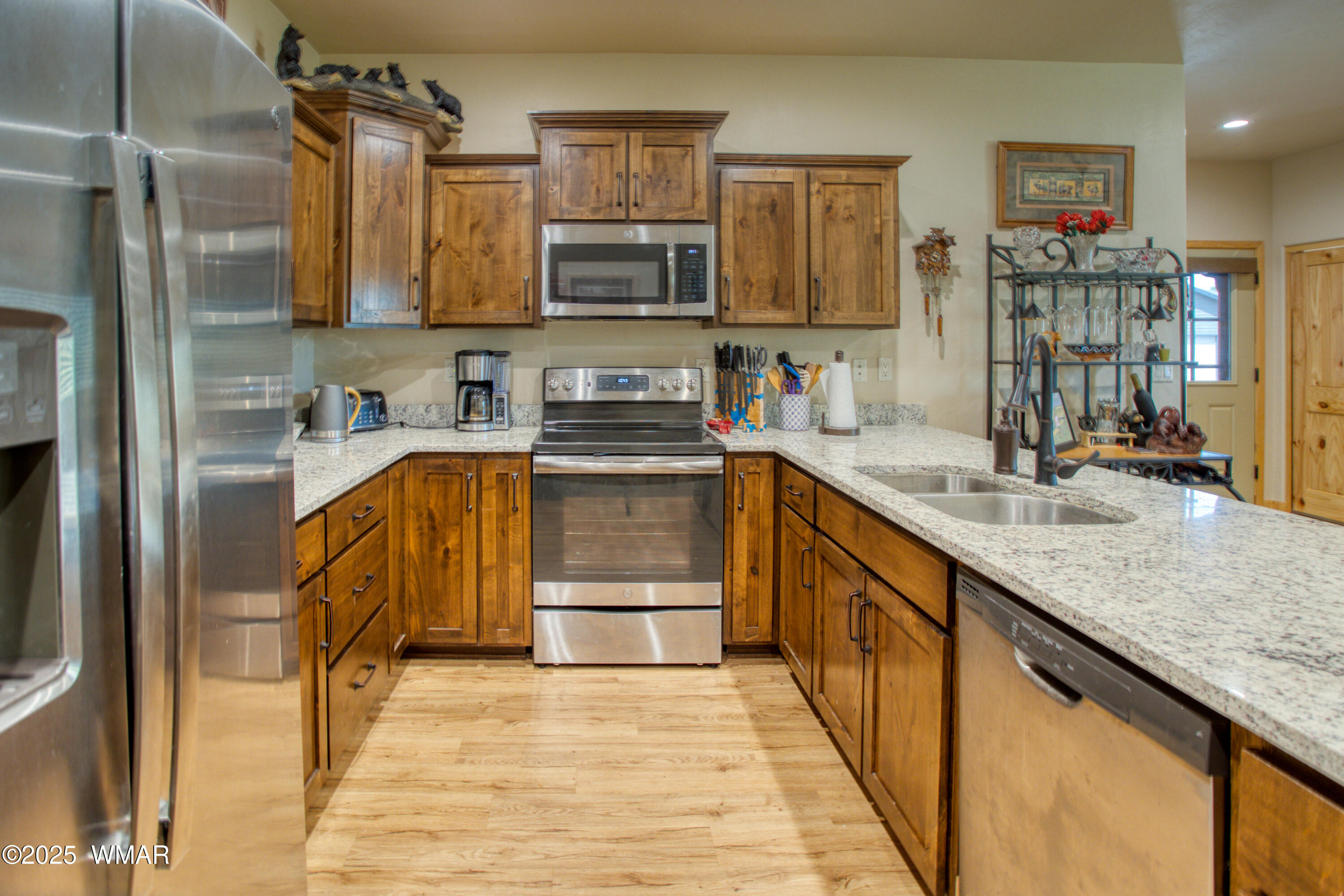 5863 Apollo Way Lakeside, AZ 85929 - Photo 3 of 16 a kitchen with stainless steel appliances granite countertop a sink stove and refrigerator