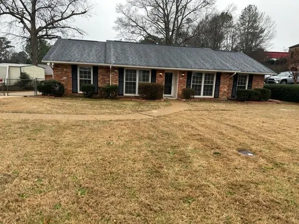 a front view of a house with a garden