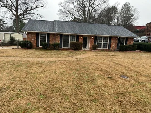 a front view of a house with a garden
