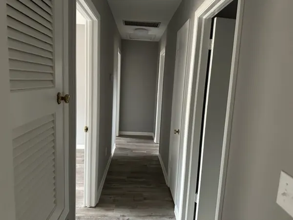 a view of a hallway with a wooden door