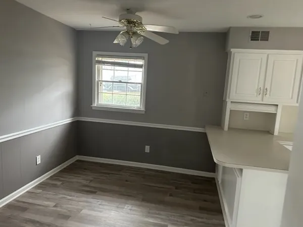 a view of room with window and ceiling fan