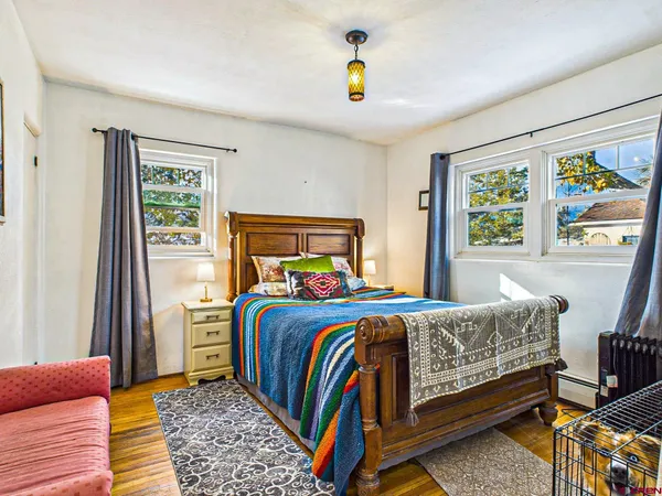 a bathroom with a granite countertop sink toilet a mirror and shower