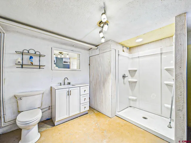 a bedroom with furniture and a wooden floor