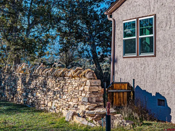 a aerial view of a house with garden space and trees
