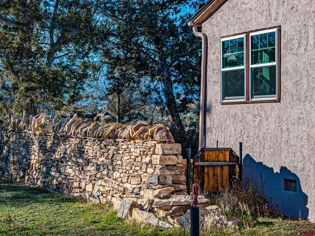 a aerial view of a house with garden space and trees