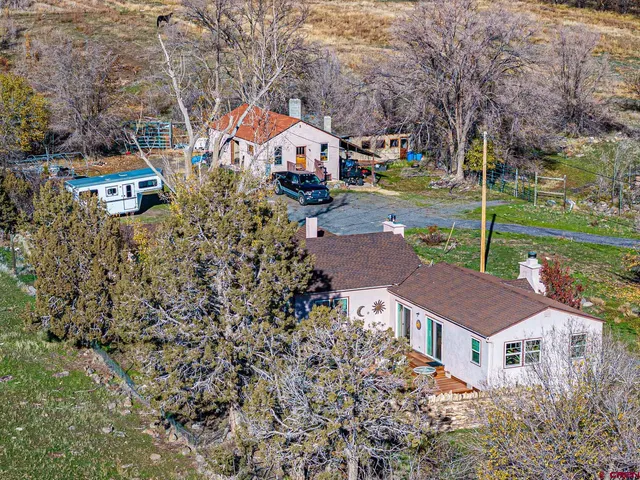 a front view of a house with garden and plants
