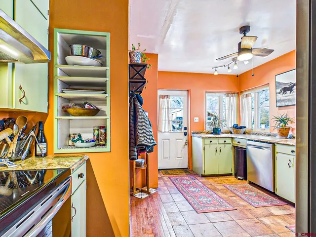 a kitchen with stainless steel appliances granite countertop a refrigerator and a sink