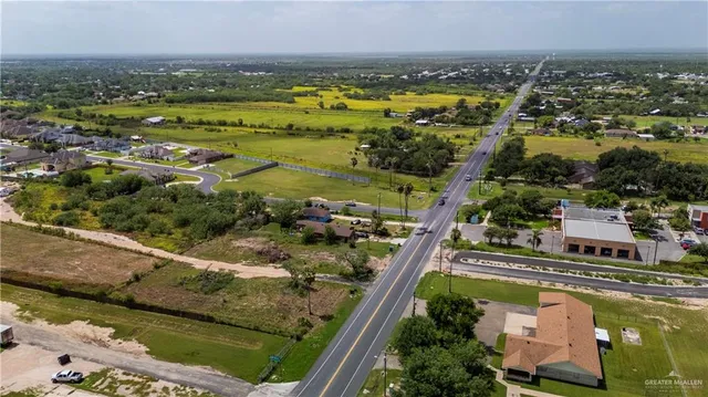 an aerial view of a house with yard and outdoor seating