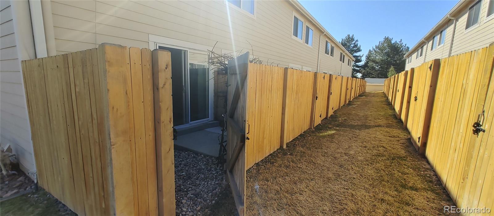 8915 Field Street, Unit 113 Westminster, CO 80021 - Photo 12 of 38 a view of a pathway door with wooden fence