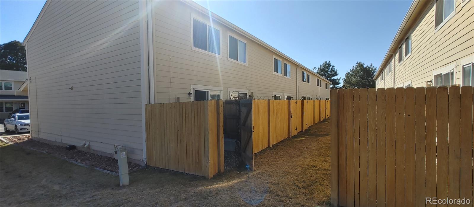 8915 Field Street, Unit 113 Westminster, CO 80021 - Photo 13 of 38 a view of a house with backyard and wooden fence