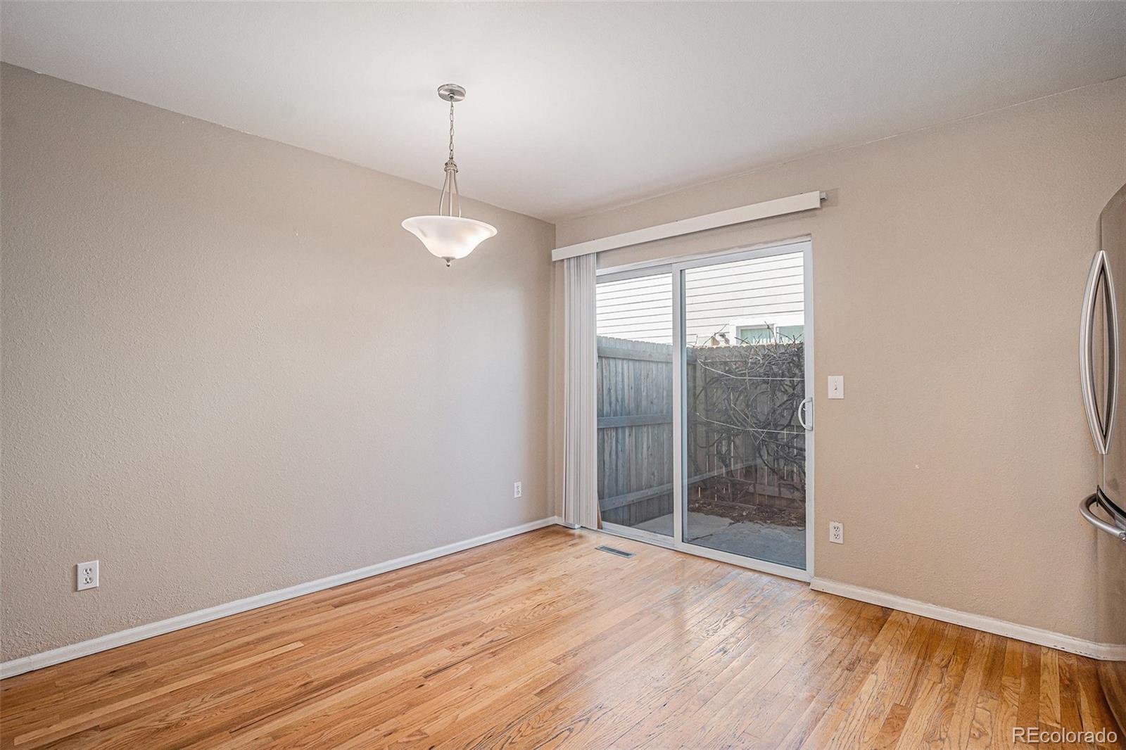 8915 Field Street, Unit 113 Westminster, CO 80021 - Photo 7 of 38 an empty room with wooden floor and windows