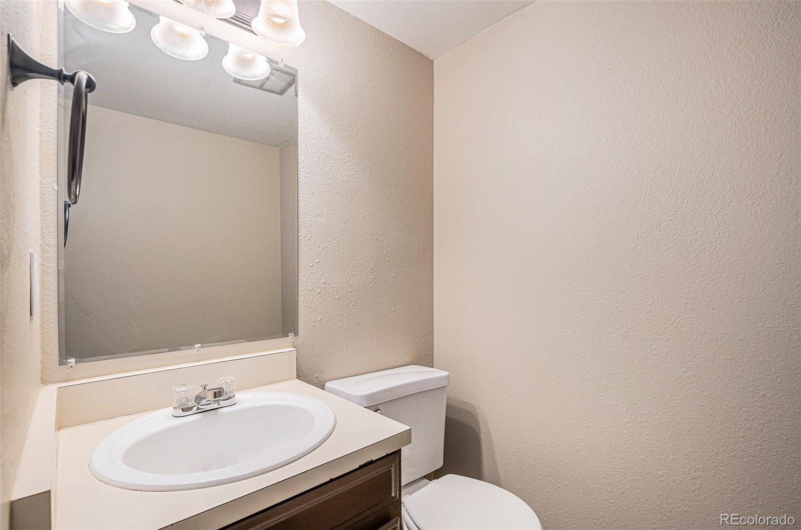 8915 Field Street, Unit 113 Westminster, CO 80021 - Photo 9 of 38 a bathroom with a sink and a mirror