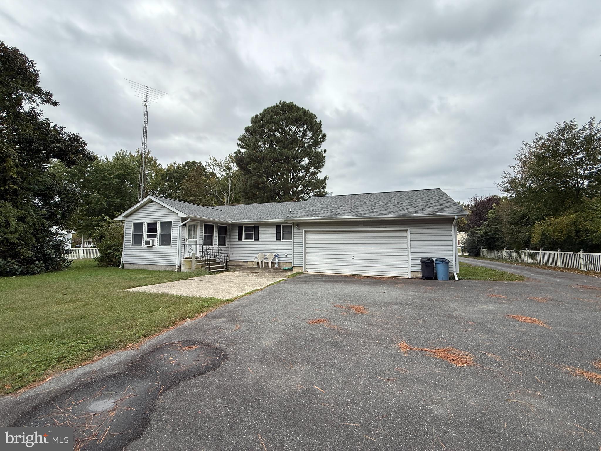 314 Kerr Avenue Denton, MD 21629 - Photo 3 of 19 a front view of a house with a yard and garage
