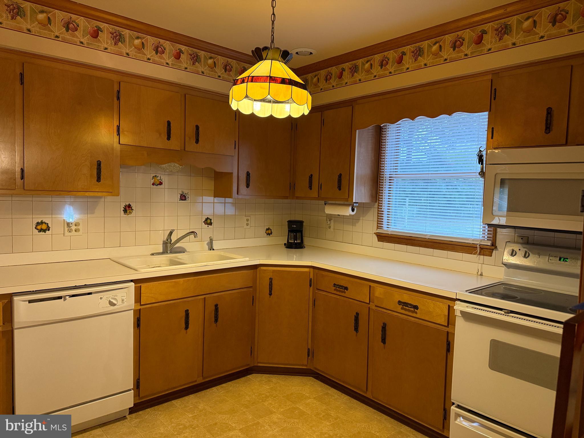 314 Kerr Avenue Denton, MD 21629 - Photo 6 of 19 a kitchen with a sink cabinets and window