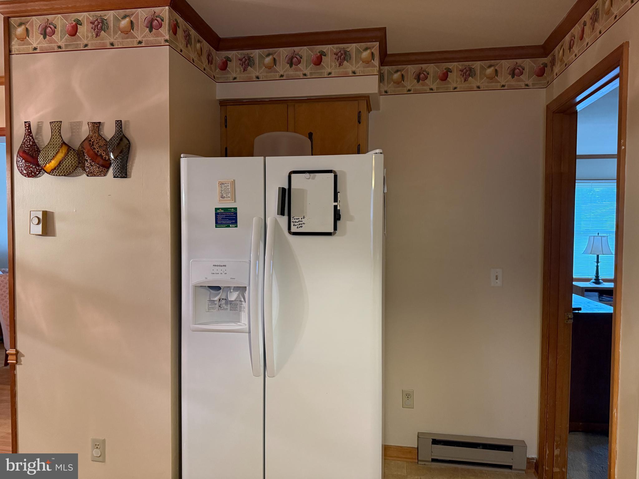 314 Kerr Avenue Denton, MD 21629 - Photo 8 of 19 a white refrigerator freezer and a table