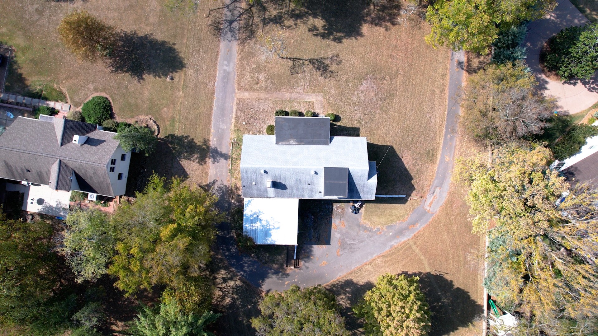 an aerial view of a house with a yard basket ball court and outdoor seating