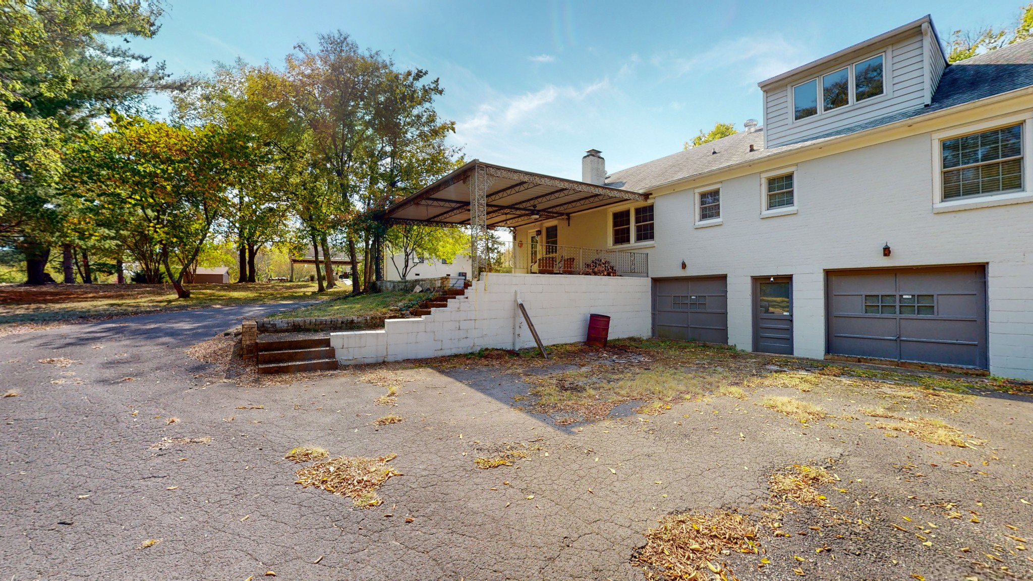 774 Elysian Fields Road Nashville, TN 37204 - Photo 16 of 43 a view of a backyard with table and chairs and a large tree