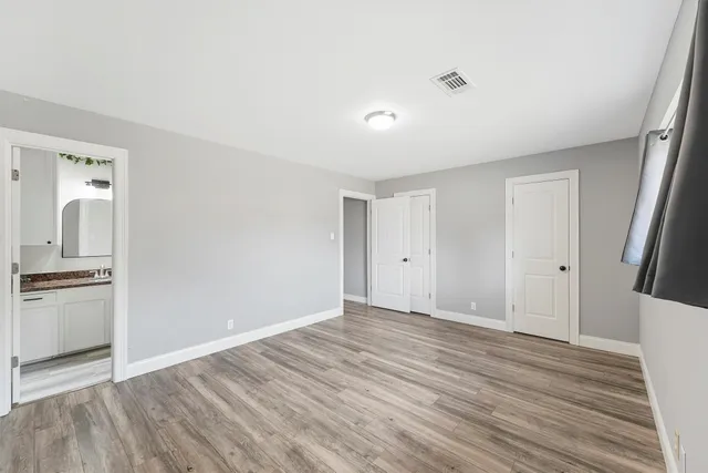 a view of a kitchen with wooden floor and a sink