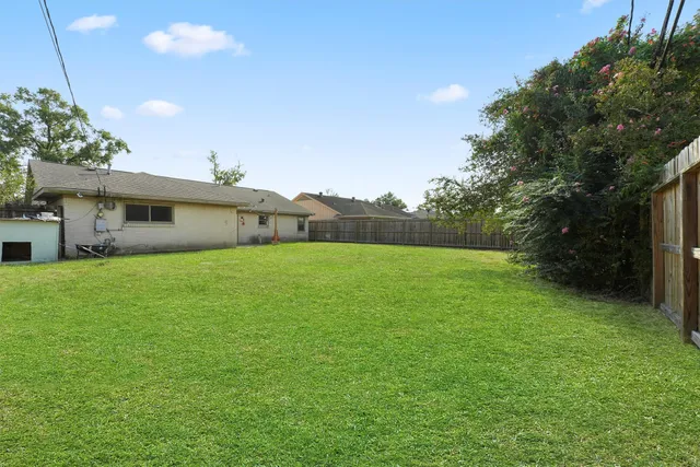 a front view of house with a garden
