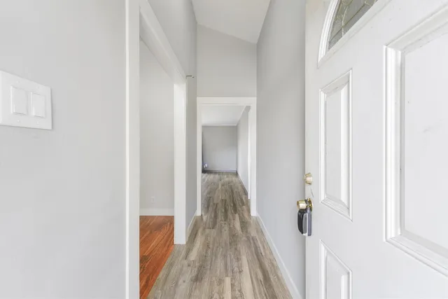 a view of a bedroom with wooden floor