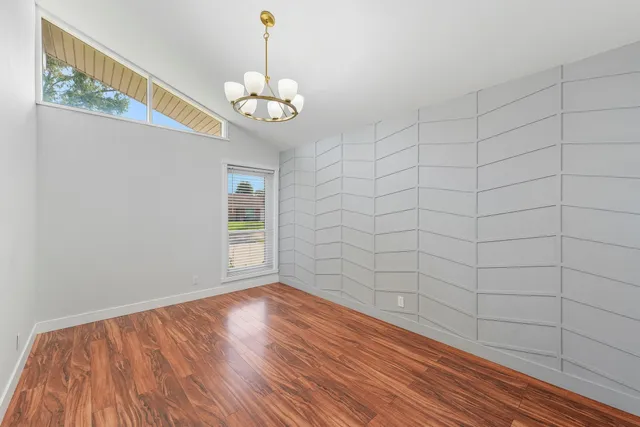 a view of a room with wooden floor and white walls