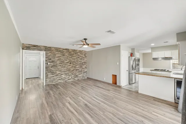 a view of kitchen with sink and wooden floor