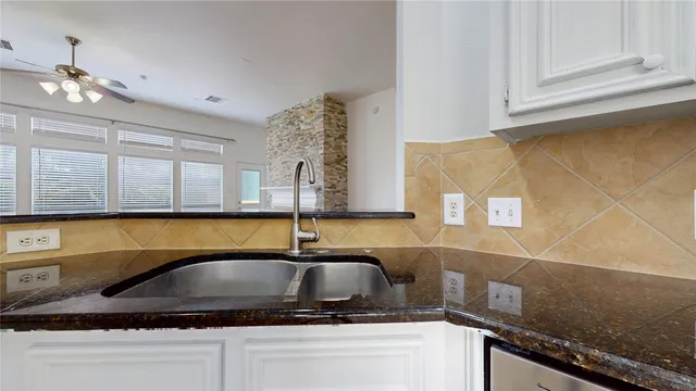 a kitchen with a sink and cabinets