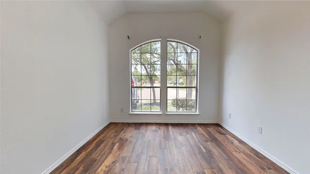 an empty room with wooden floor windows and with wooden floor