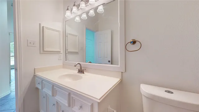 a bathroom with a sink vanity and a mirror