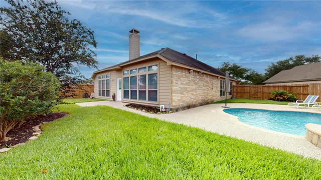 a view of a house with a backyard