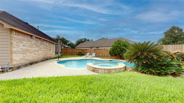 a view of a backyard with plants and a patio