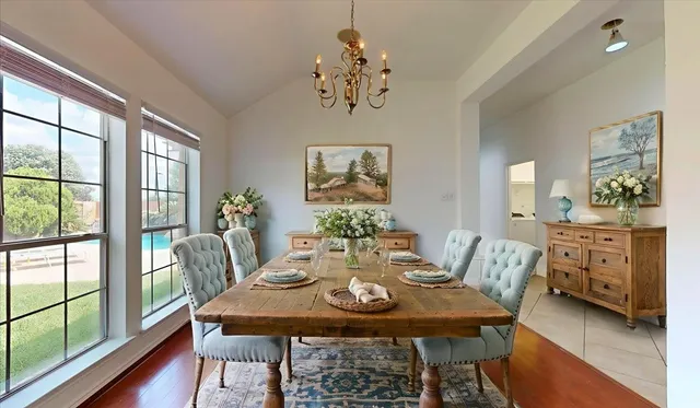 a view of a dining room with furniture a chandelier and wooden floor