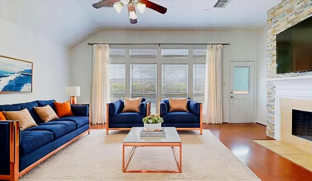 a living room with furniture fireplace and flat screen tv