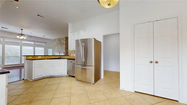a kitchen with a refrigerator and microwave