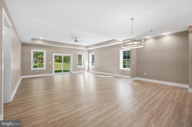 a view of a livingroom with wooden floor and window