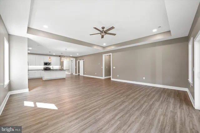 a view of a living room a kitchen and a sink