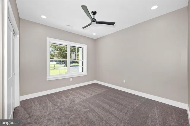 a view of a livingroom with a ceiling fan and window