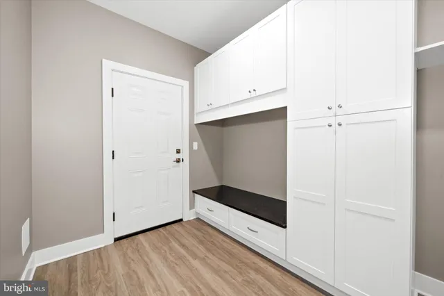 a view of a room with wooden floor