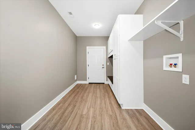 a view of a hallway with wooden floor