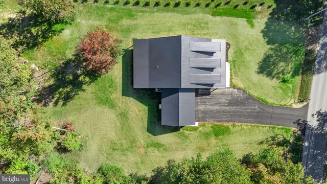 an aerial view of a house with a yard