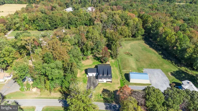 an aerial view of a house with yard swimming pool and outdoor seating