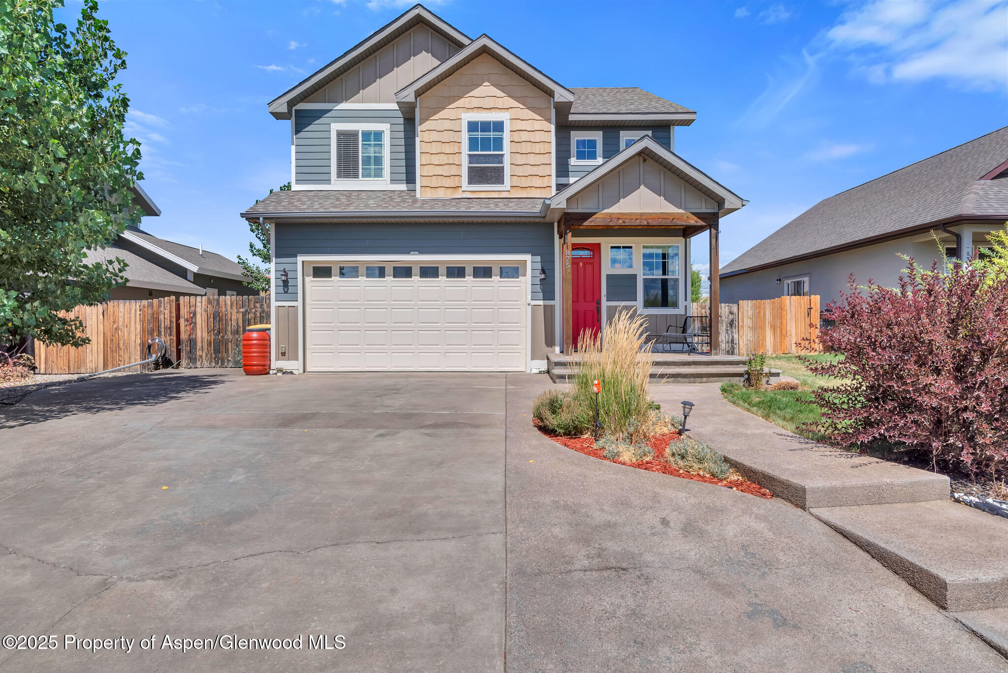 875 Dry Creek Road Hayden, CO 81639 - Photo 2 of 40 a front view of a house with a yard and garage