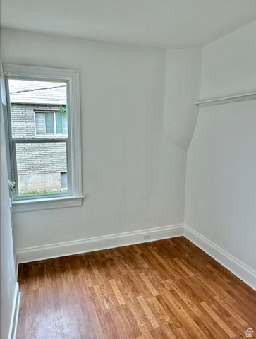 1050 West 100 North Provo, UT 84601 - Photo 15 of 16 Bright room featuring wood-finish flooring, white painted walls, a single window, and white trim