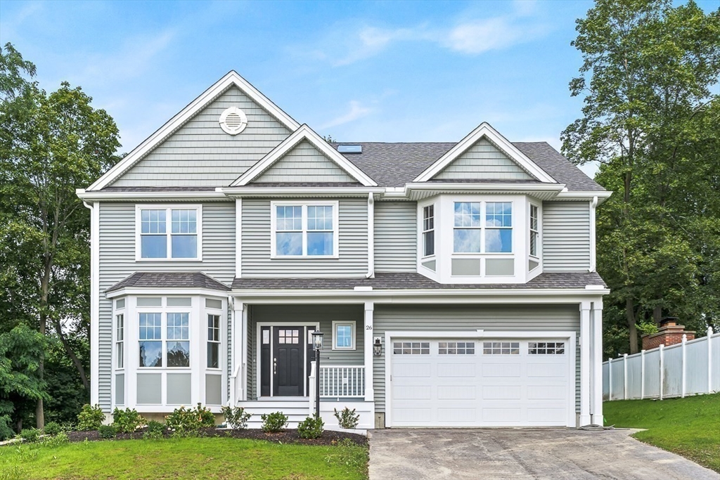 26 Flagg Street Woburn, MA 01801 - Photo 1 of 41 a front view of a house with a garden and yard