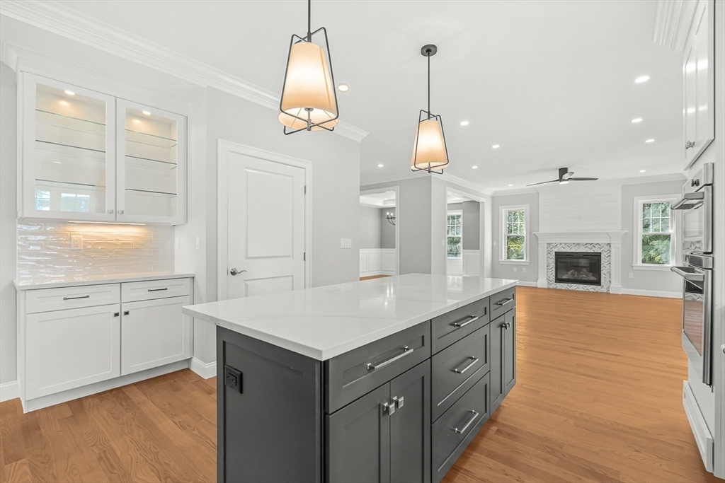 26 Flagg Street Woburn, MA 01801 - Photo 13 of 41 a large kitchen with kitchen island granite countertop a stove a sink a island and a wooden floors