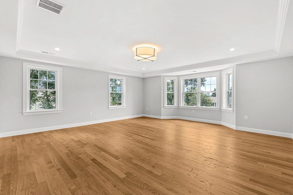 26 Flagg Street Woburn, MA 01801 - Photo 23 of 41 an empty room with wooden floor and windows